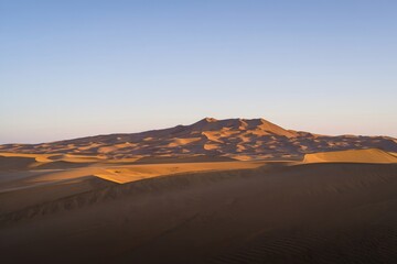 Majestic Sand Dunes and Mountain Range at Sunset - Desert Landscape