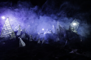 A silhouette of a person against the background of shattered glass. An abstract world made of glass shards. Surreal concept. Table top decoration.