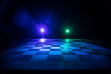 Chess board game concept of business ideas and competition. Chess figures on a dark background with smoke and fog.