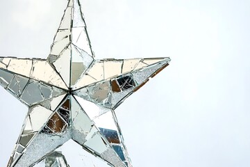 A shattered glass star ornament reflecting light in sparkling, fragmented patterns.