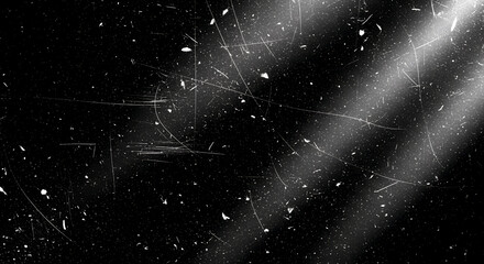 Film dust and scratches with light beams on black – grunge overlay texture, High‑contrast black background covered with vintage film dust, scratches, and diagonal light rays