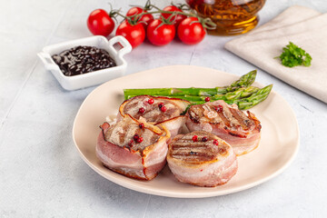 Tasty grilled pork medallion with bacon