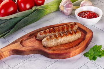 Grilled pork sausages served tomato sauce