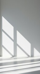 Fototapeta premium Abstract white wall background featuring strong geometric shadows cast by window frames, creating a moody, architectural minimalist aesthetic ,backdrop ,mockup ,shadow
