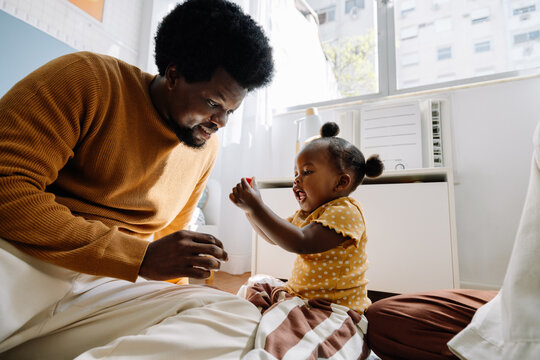 Father and daughter playing together at home