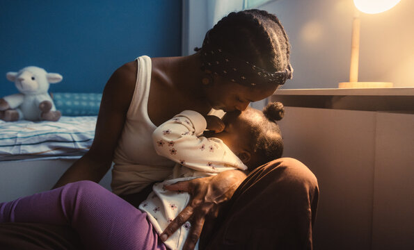 Mother embraces child during bedtime