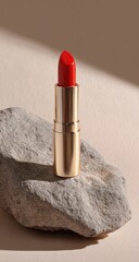 Red lipstick on grey stone, beige background, soft light