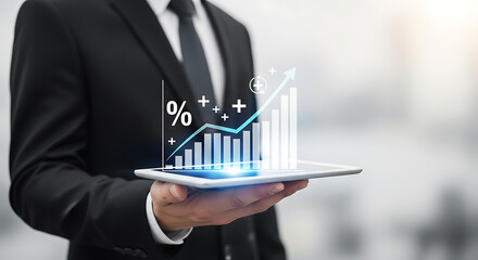Man in suit holding tablet displaying a rising bar graph with percentage and plus signs overlayed
