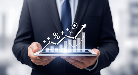A businessman holding a tablet displaying an upward trending bar graph with percentage symbols