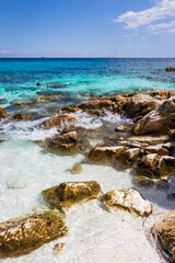 A view of the white marble beach and crystal-clear water
