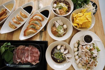 Overhead View of a Full Thai Noodle and Side Dish Spread