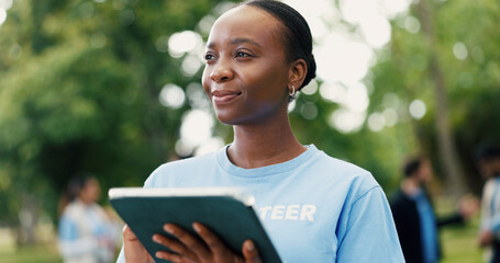 Woman, volunteer and thinking with tablet in nature for eco friendly development or campaign. Female person, activist or thoughtful NGO with technology for environmental growth or change in park