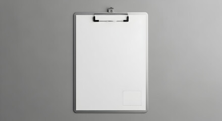 Clean clipboard with blank white paper and silver clip sits on a neutral grey background, perfect for mockups and design presentations.
