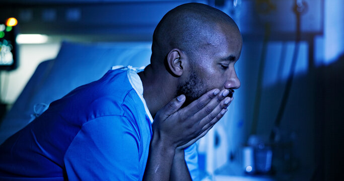 Sad, black man and patient on hospital bed at night with finance anxiety, stress or insomnia. Depression, clinic and person worry for health crisis, sleepless and cancer diagnosis with medical debt
