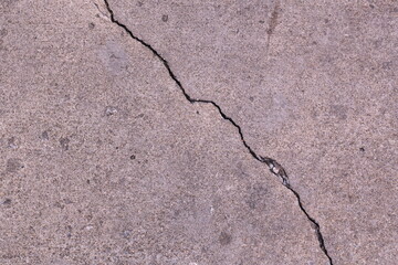 Detailed Close-Up of a Cracked Concrete Surface with Visible Texture and Patterns