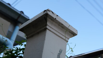 Close-Up of Weathered Architectural Column with Clear Blue Sky in Background