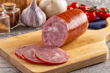 Ham sausage with slice over board