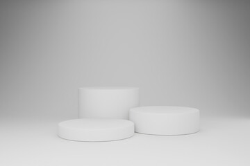 The white cylindrical objects are resting on the gray background