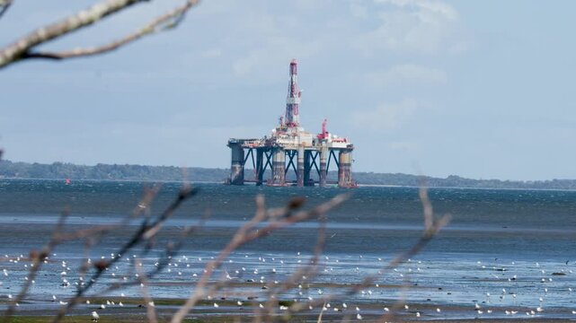 Offshore Oil Rig Viewed Across Cromarty Coastline at Low Tide