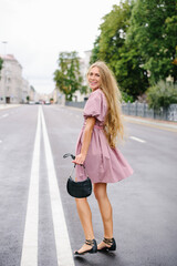 Smiling Woman With Handbag On Empty City Street