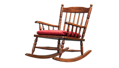 Isolated classic wooden rocking chair with a red cushion, against a stark black background