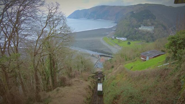 The Lynton to Lynmouth Funicular hillside Railway with the cliffs of Exmoor National Park and beach in the background