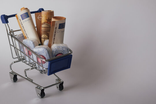 Cost of living: expensive dishwasher tablets next to euro currency, showing household expense