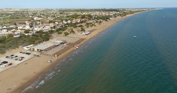Aerial view of a sandy beach overlooking the Mediterranean Sea. This is the beach of Santa Maria del Focallo, a small tourist and coastal town in the municipality of Ispica, in Sicily, Italy.