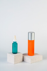 Cosmetic product in tube, bottle, lotion or serum with stylish props on white background. 