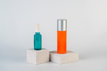 Cosmetic product in tube, bottle, lotion or serum with stylish props on white background. 