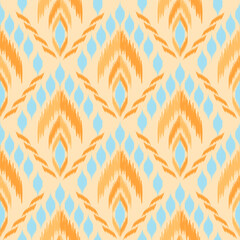 Ikat seamless pattern with floral elements and ogee shapes in orange and soft blue background. Unique style for textile design. 