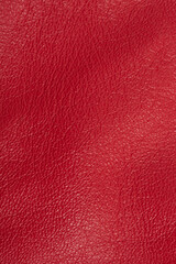Red leather background macro photo. Red leather texture vertical photo.