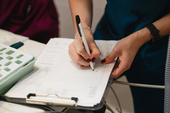 Veterinary professional writing medical chart in clinic