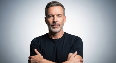 Confident mature man with gray hair and beard in casual black shirt