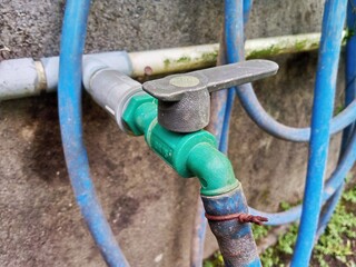 Garden Hose Connected to Water Faucet for Outdoor Use