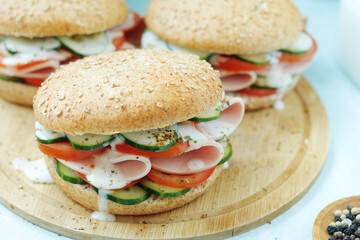 Bun sandwiches with salami and vegetables	