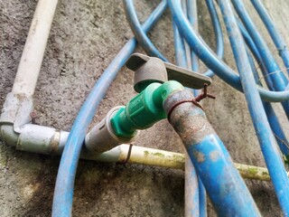 Garden Hose Connected to Water Faucet for Outdoor Use
