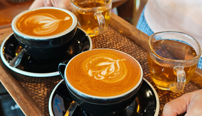 Barista making latte art, pouring cappuccino
