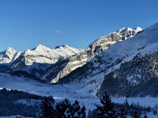Breathtaking Swiss mountain landscape in winter with clear morning light, deep fresh snow under a blue sky, Kandersteg, Sunnbüel, Bernese Oberland, Switzerland