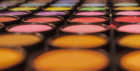 Abstract macro close-up of a colorful makeup or artist paint palette with shallow depth of field. Symbolize creativity, art, and cosmetics
