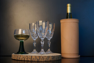 Crystal wine glasses and a bottle of wine in a cooler