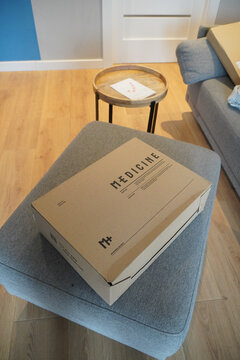 Medicine box on a gray ottoman in a modern living room setting