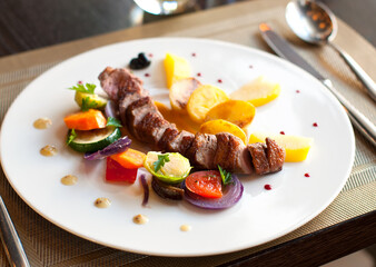 Grilled pork loin with vegetables on a plate in restaurant