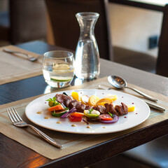Grilled pork loin with vegetables on a plate in restaurant