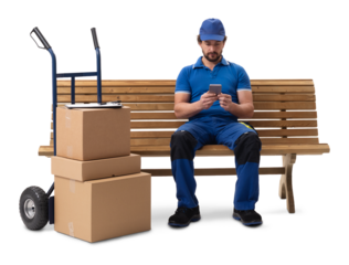 A delivery courier sitting on a bench with a hand cart of parcels, using a smartphone, isolated on a white background.