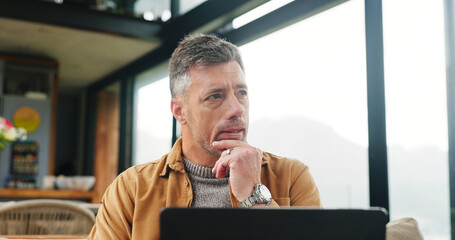 Holiday, laptop and thinking with man on sofa in living room of home for vacation planning....