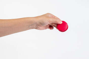 Red macarons in hand on white background