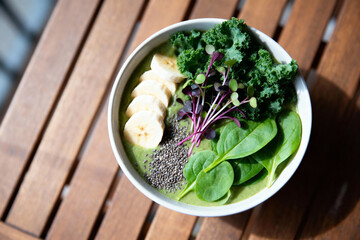 Superfood Detox Smoothie Bowl with Kale, Spinach, Banana, Chia Seeds and Microgreens for Clean Nutrition, Wellness Energy and Healthy Green Eating