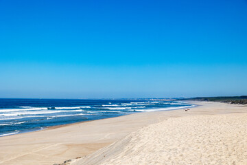 Wide sandy Atlantic beach with rolling waves under clear blue sky Portugal, Ovar – Furadouro, 10 October 2025