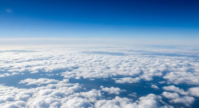 Blue sky and fluffy white clouds from high altitude, aerial view of serene natural cloudscape horizon background